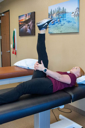 Therapist demonstrating hamstring stretch