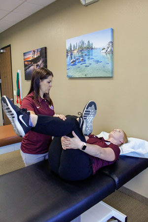 Therapist demonstrating the modified piriformis stretch